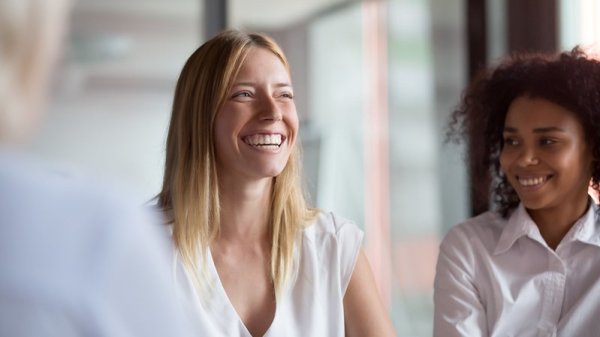 Image of two professional women smiling. 